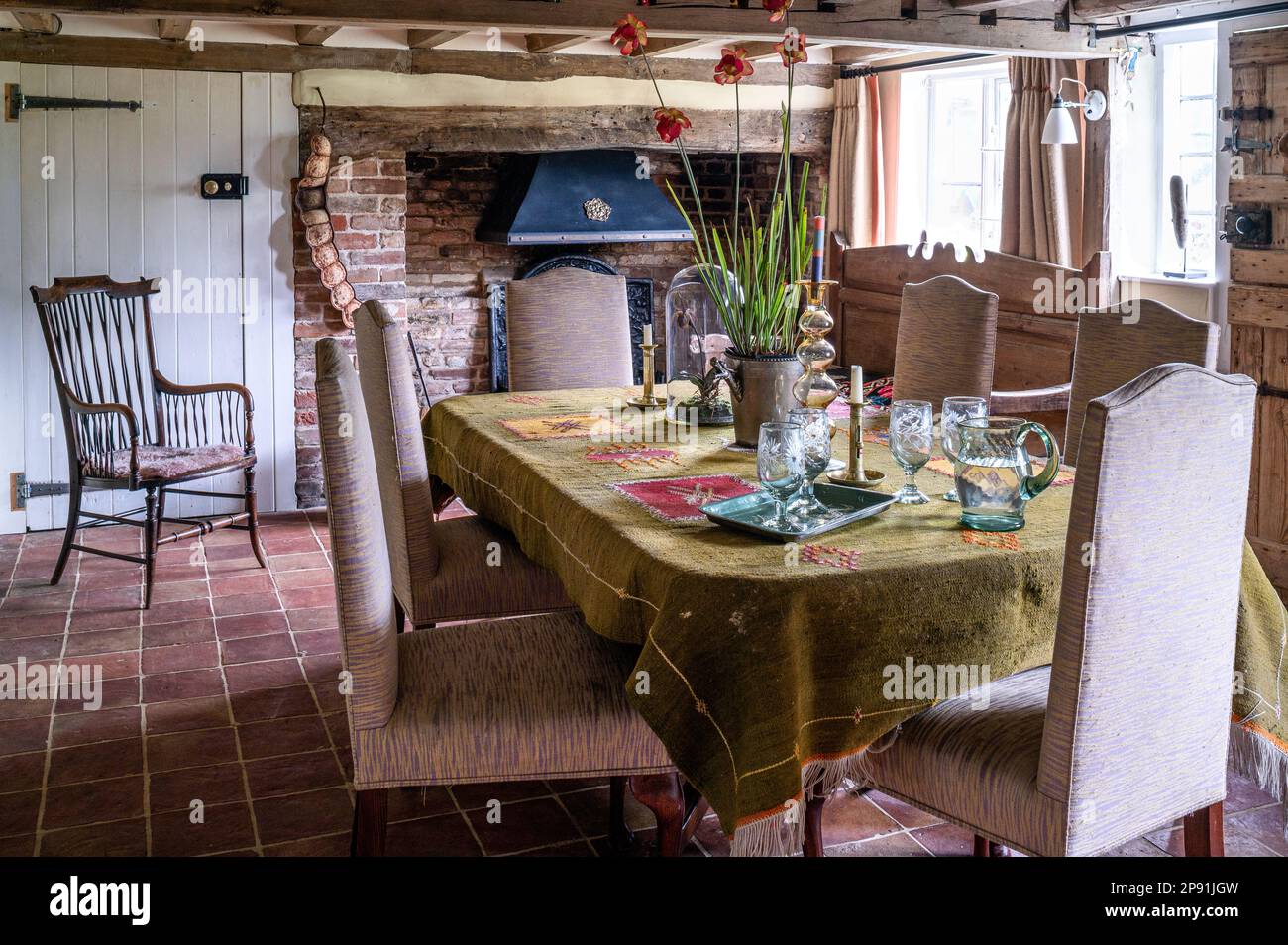 Dining room with low ceiling and tapestry cloth in 16th century Tudor farmhouse, Suffolk, UK. Stock Photo