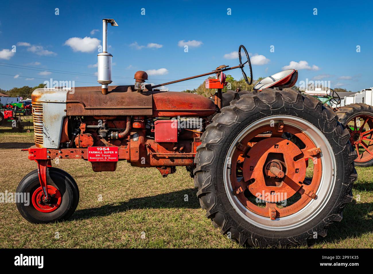 Fort Meade, FL - February 26, 2022: High perspective side view of a 1954 International Harvester McCormick Farmall Super H Tractor at a local tractor Stock Photo
