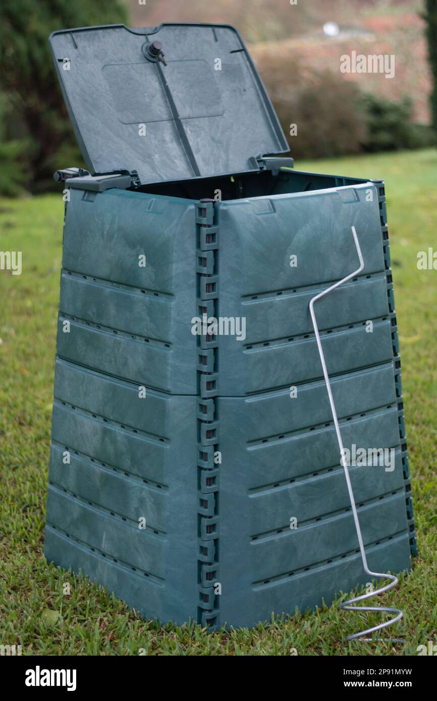 Outdoor compost bin placed in a home garden to reduce the organic waste