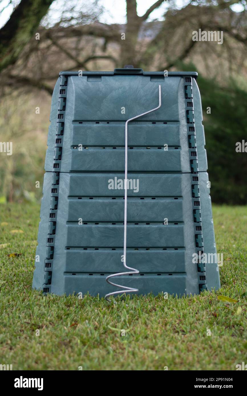 Outdoor compost bin placed in a home garden to reduce the organic waste ...