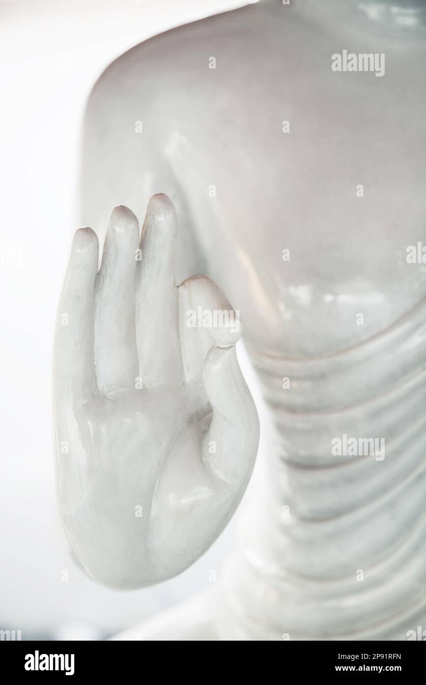 White Buddha statue hand gesture close-up. Asian symbolic ok mudra ...