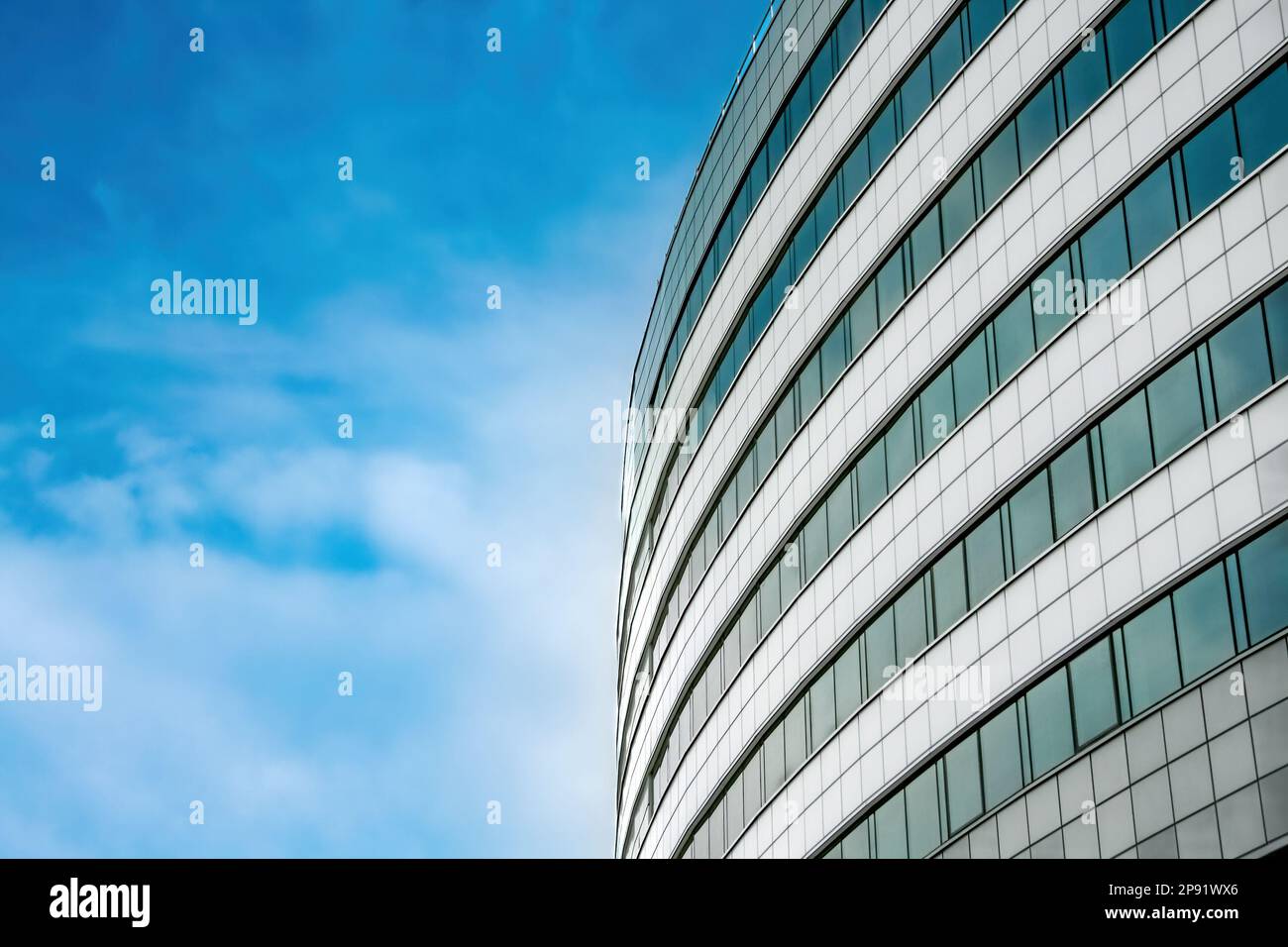 The facade of a modern building at an angle against a blue sky ...