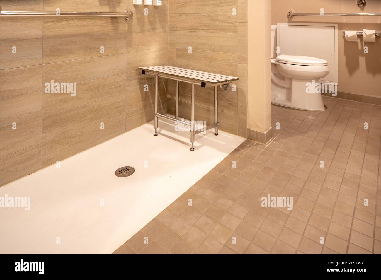 Wheelchair accessible hotel bathroom shower with tile floor and walls Stock Photo Alamy