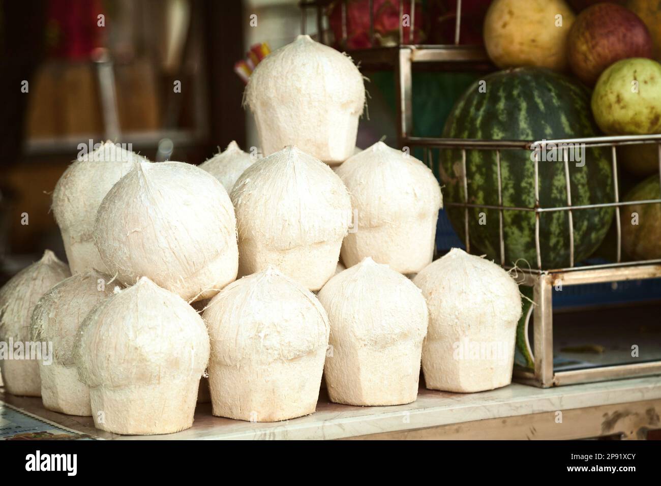 Pile of peeled cocos for drinking in a juice bar. Many coconuts and