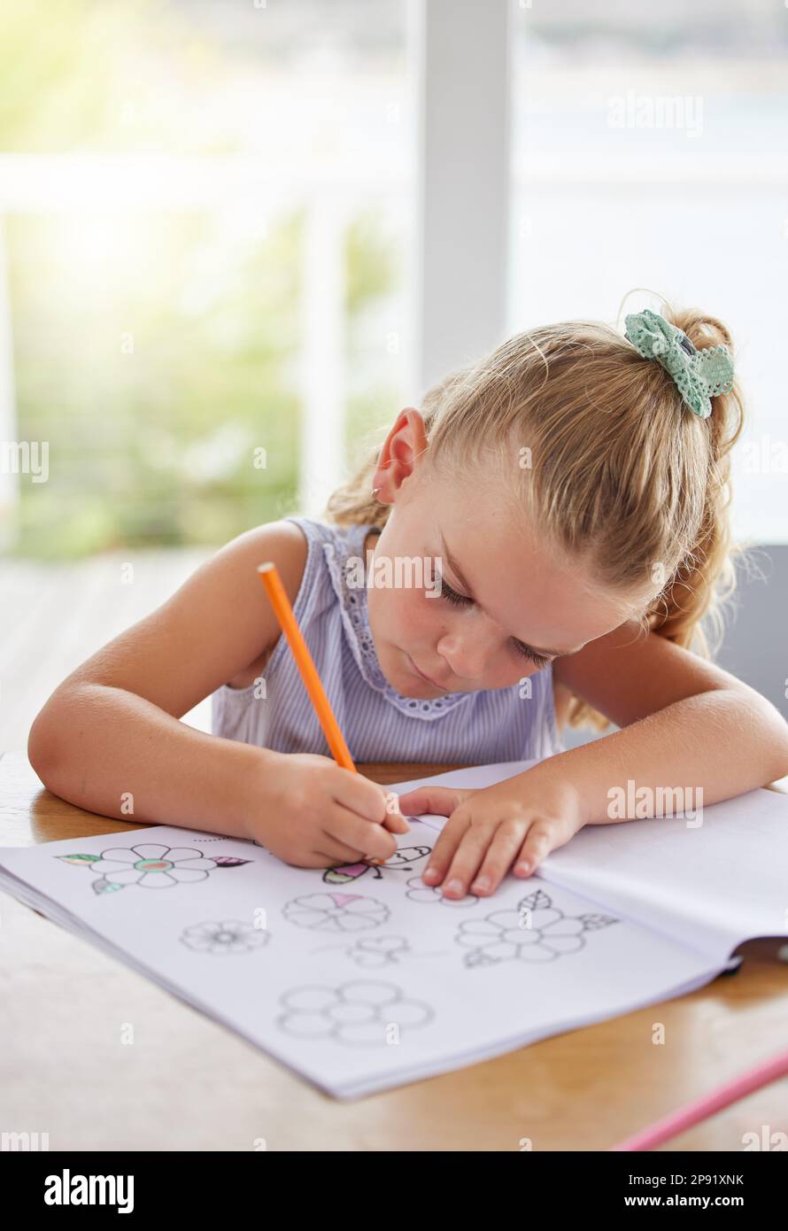 Education, art and girl learning to draw at a table, having fun with colors and paper sketch in her home. Growth, development and creative activity Stock Photo