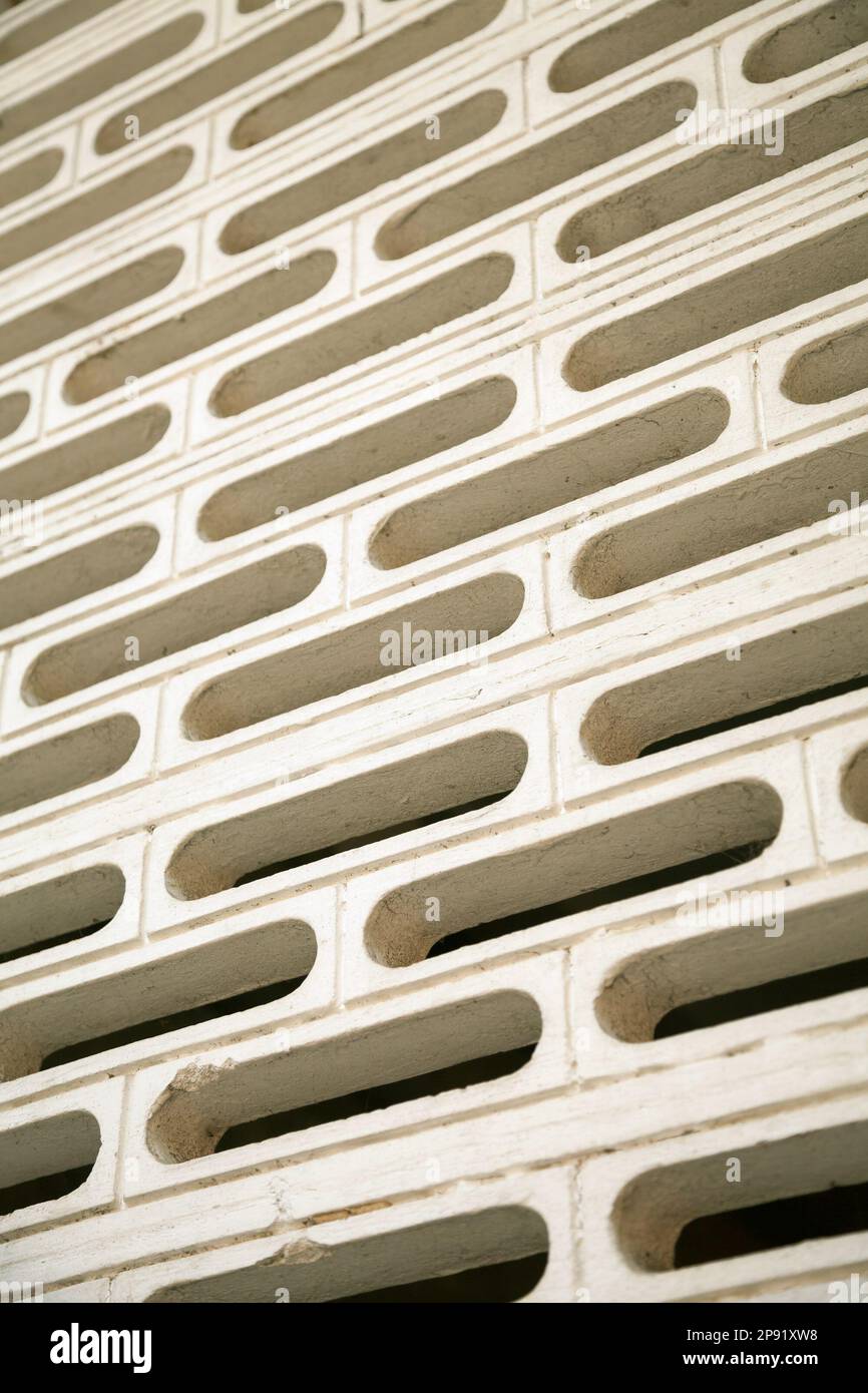 Architecture geometry white pattern background. Black holes in a white wall backdrop. Modern building design detail Stock Photo