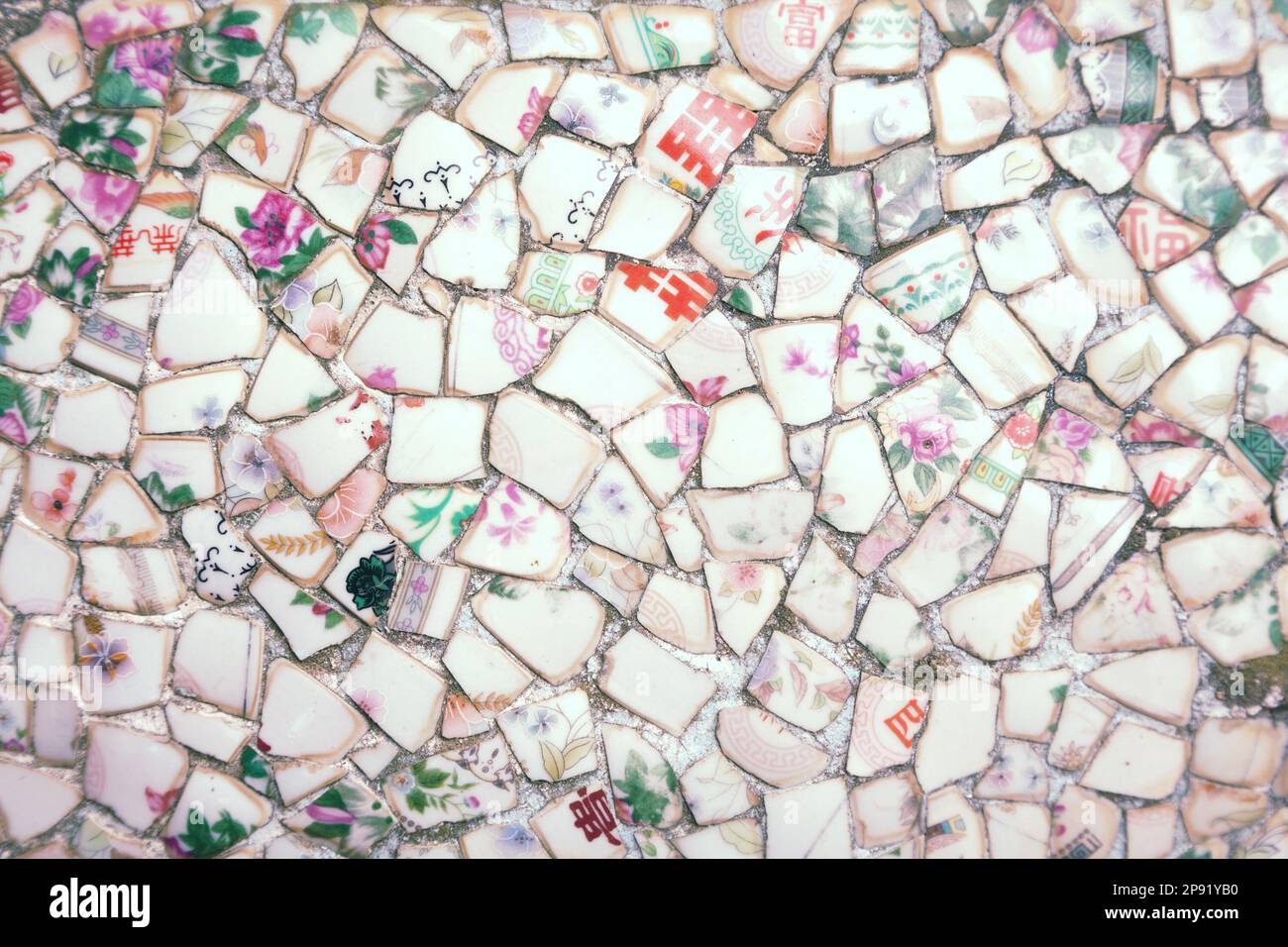 Mosaic made of broken crockery and tableware background. Wall tiled