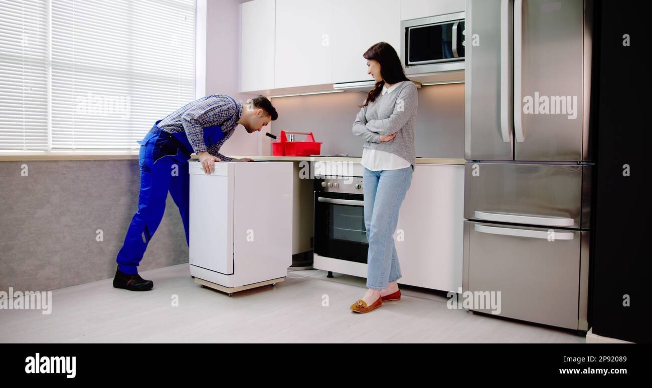 Dishwasher Appliance Install. Repairman Moving Washer Machine Stock