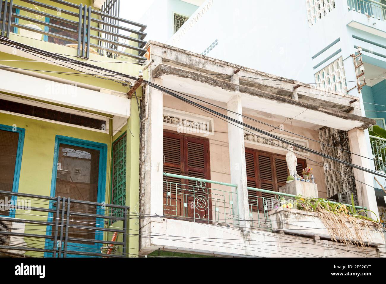 Vietnamese apartment building wall closeup with balconies. City street