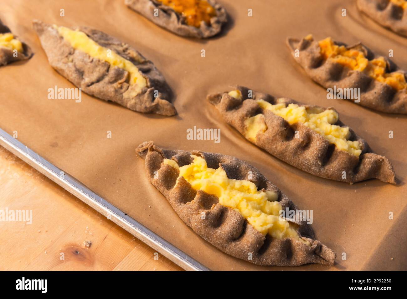 Homemade Karelian pasties with mashed potato and carrot, close up photo with selective soft focus Stock Photo