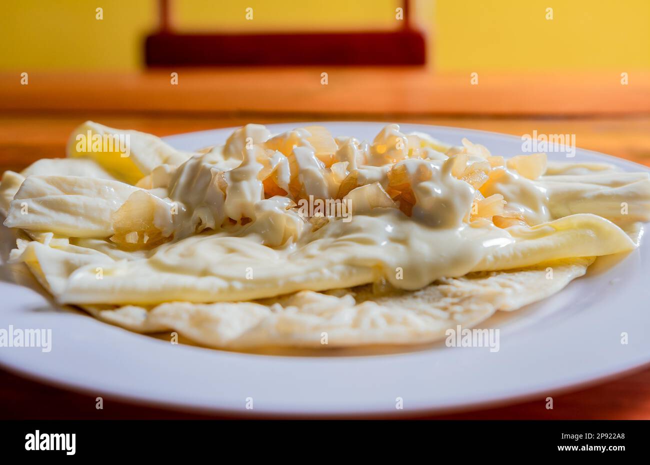 Traditional Cheese with Pickled Onion, Traditional cheese dish with pickled onion and cream. Concept of typical foods of latin america Stock Photo
