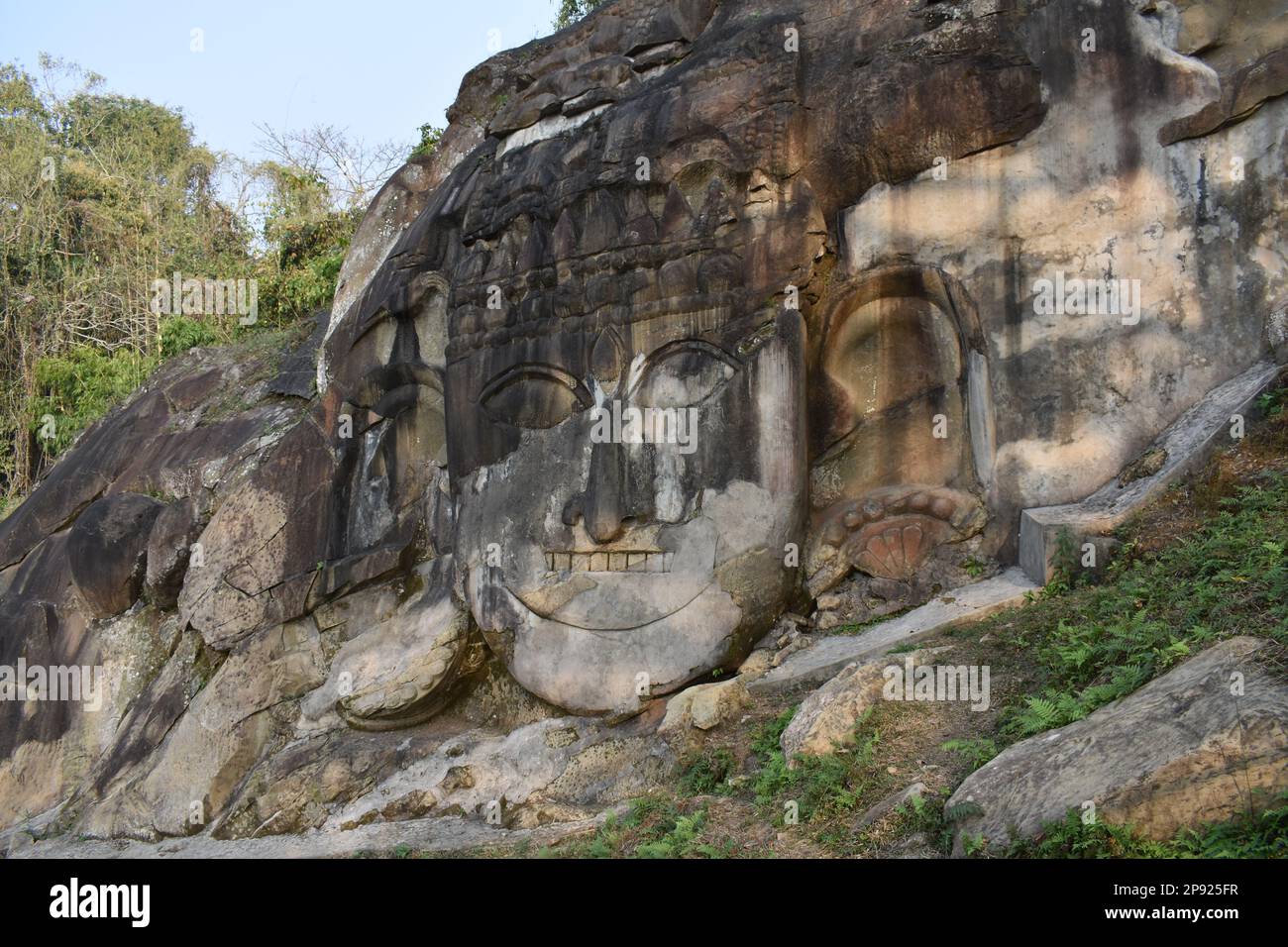 Lord Shiva sculpture carved in a mountain in Unokoti , Tripura , India . A thousand years old structure . Stock Photo