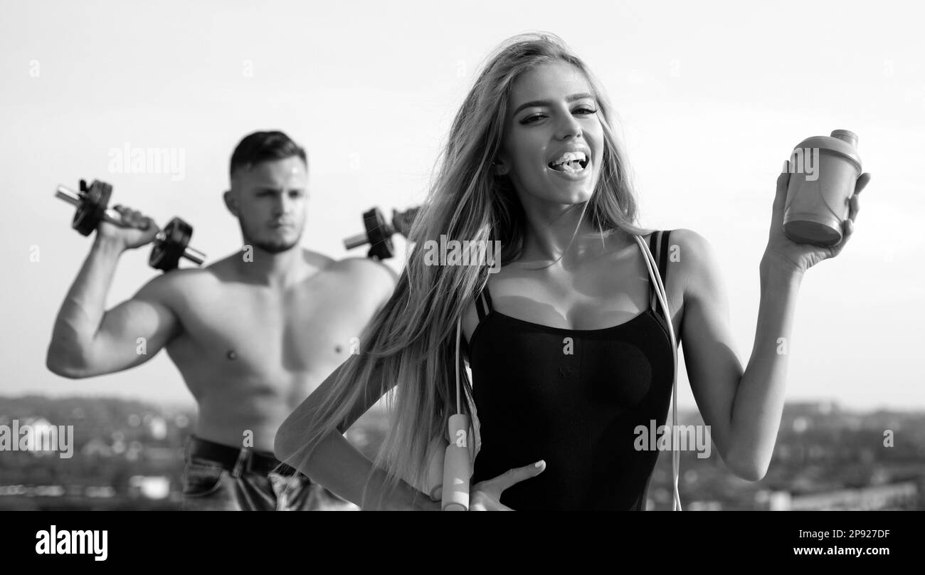 https://c8.alamy.com/comp/2P927DF/female-fitness-coach-with-protein-shaker-man-and-girl-with-protein-shake-bottle-and-skipping-rope-smiling-young-woman-and-personal-couple-trainer-2P927DF.jpg