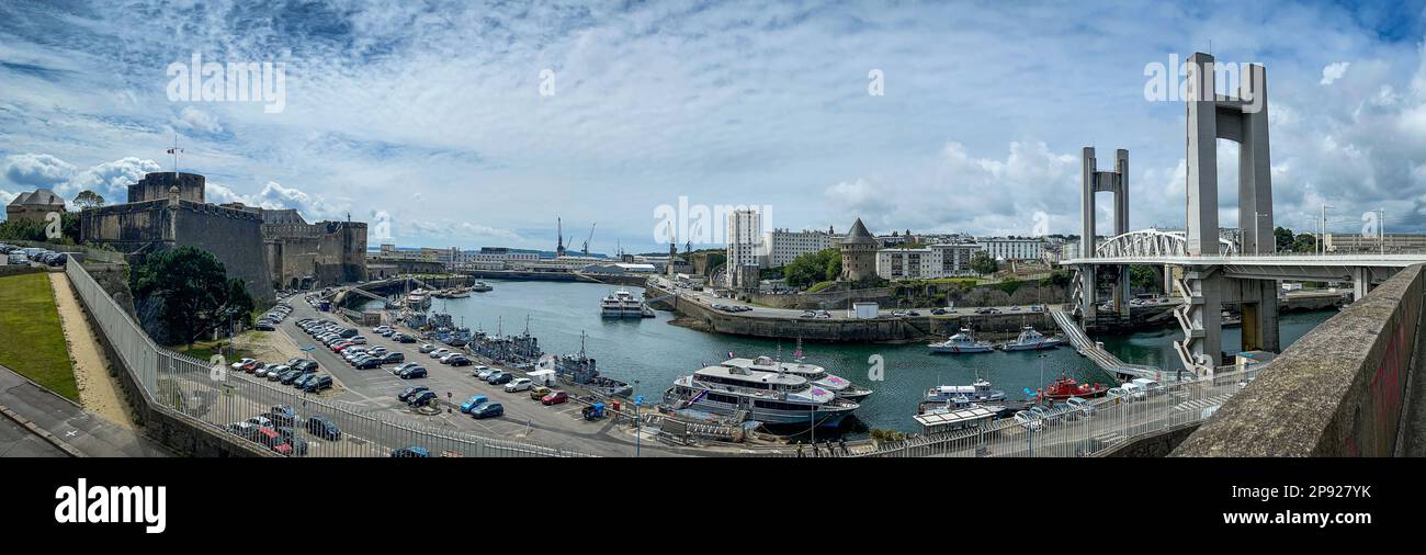 A panoramic shot of a bustling harbor area with a bridge in the background in Brest, France. Stock Photo