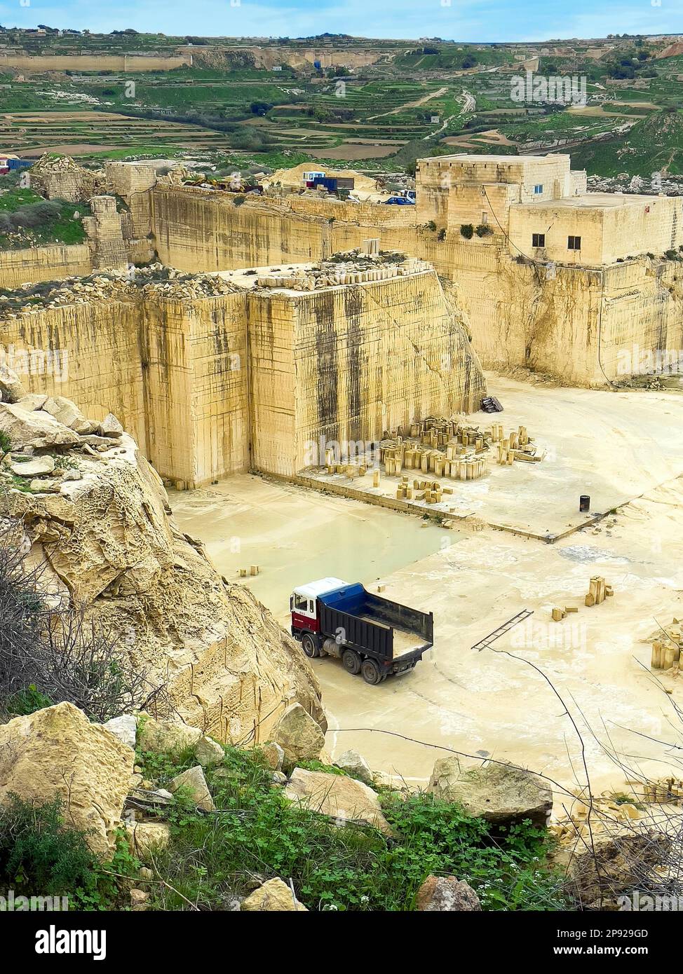 View from above in quarry of sandstone sand-lime brick, in the background vertically cut quarried rock, in the middle of the picture truck for Stock Photo