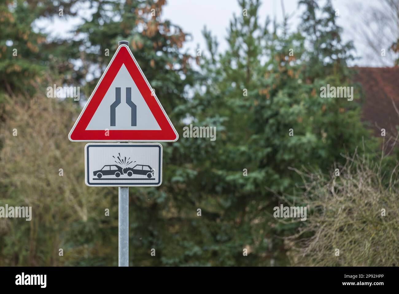 A traffic sign with the meaning , lane narrowing on both sides and the additional sign danger of collision Stock Photo