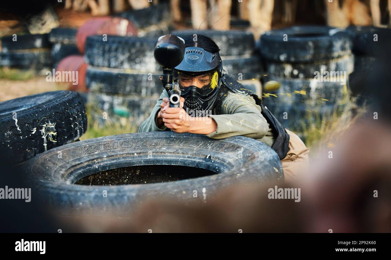 Paintball, person aim gun at target and military tactics, shooting range and war game for sports outdoor. Soldier with weapon on battlefield, action Stock Photo