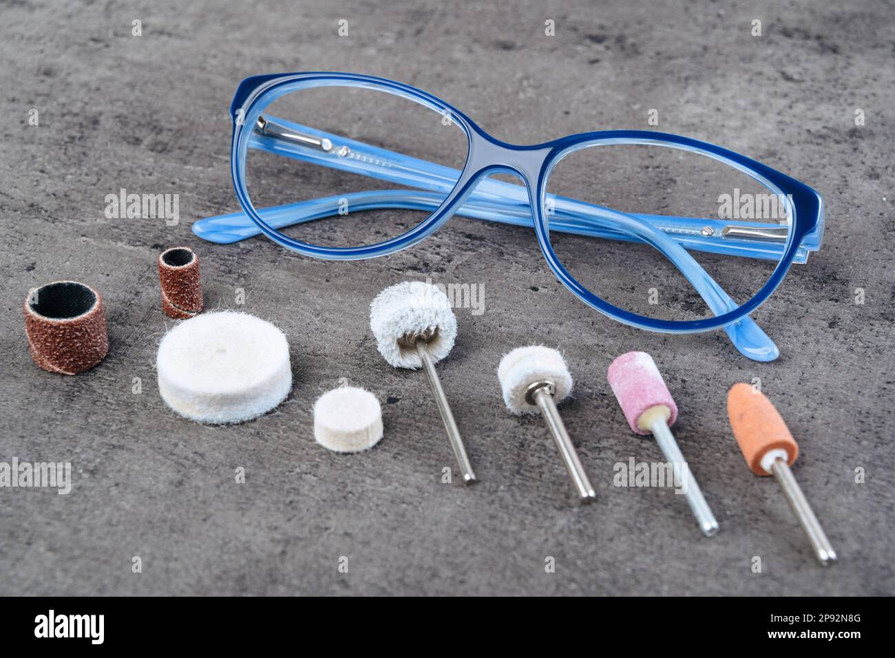 Closeup of blue medical glasses with many different rotary heads for polishing. Grind kit for optician workshop. Vision and ophthalmology concept Stock Photo Alamy