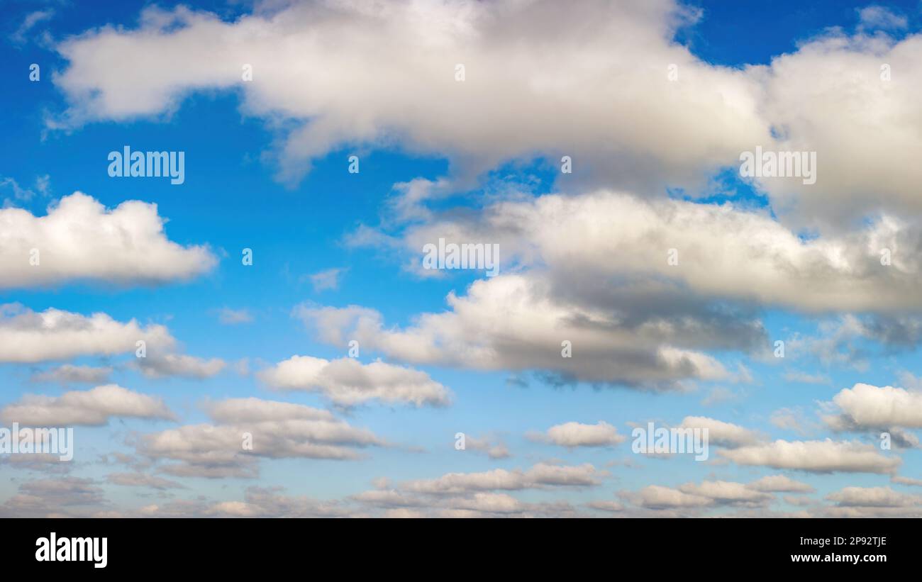 Bright blue sky with white clouds. Background image Stock Photo - Alamy