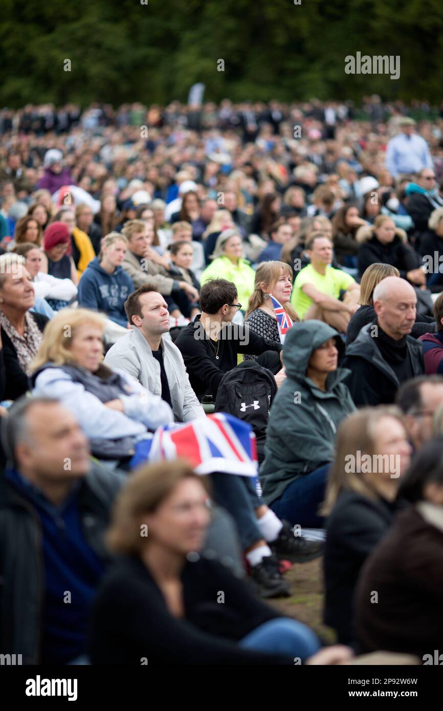 People watch the TV coverage of the late Queen Elizabeth II’s funeral