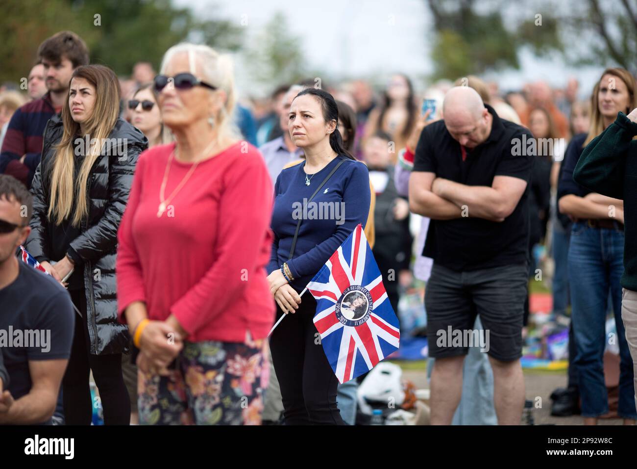 People watch the TV coverage of the late Queen Elizabeth II’s funeral