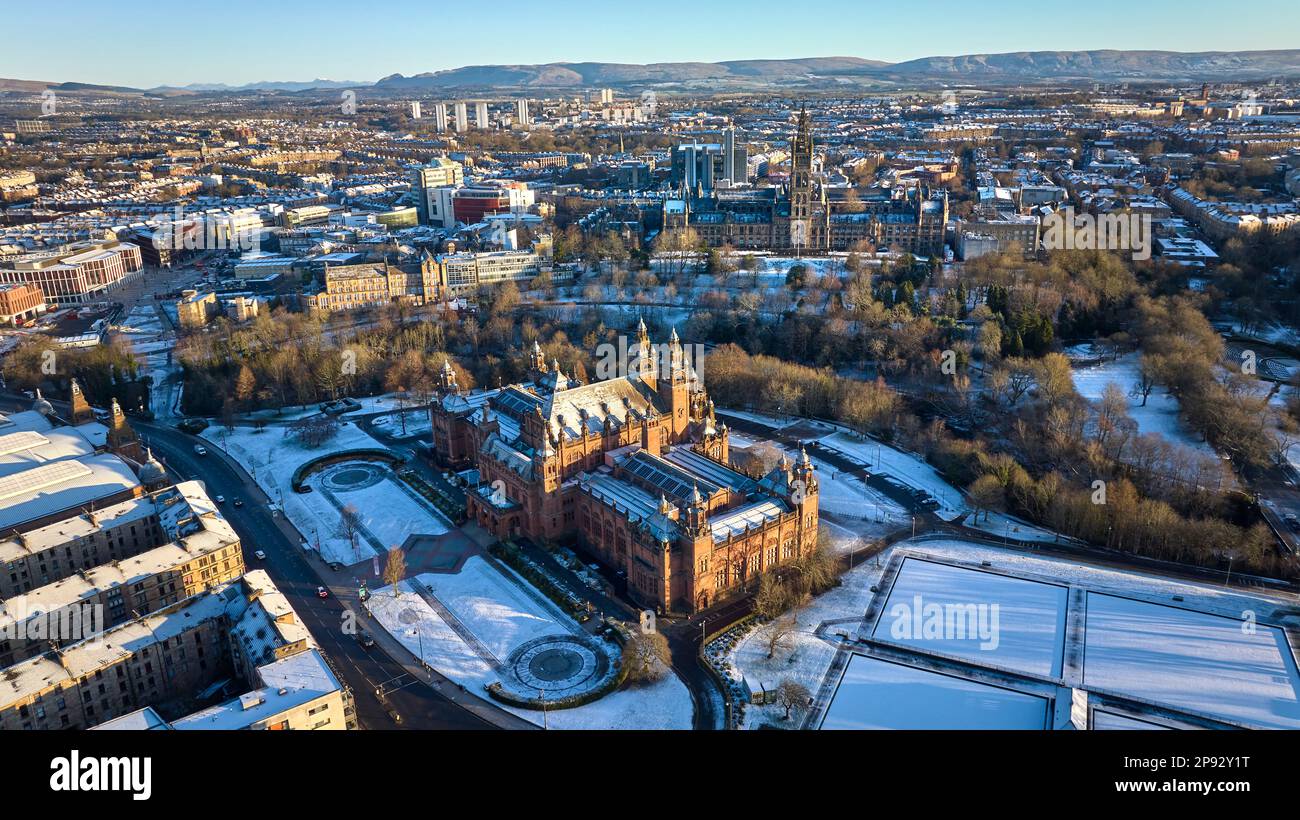 Aerial view of University of Glasgow and Kelvingrove Art Gallery and Museum from above Kelvingrove Park on a snowy spring morning. Stock Photo