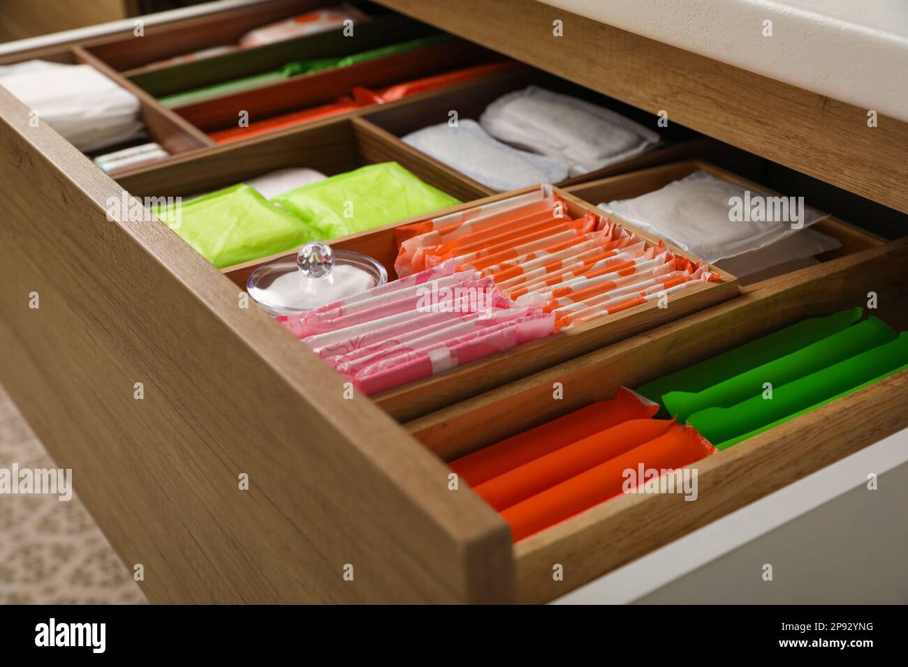 Storage of different feminine hygiene products in wooden drawer
