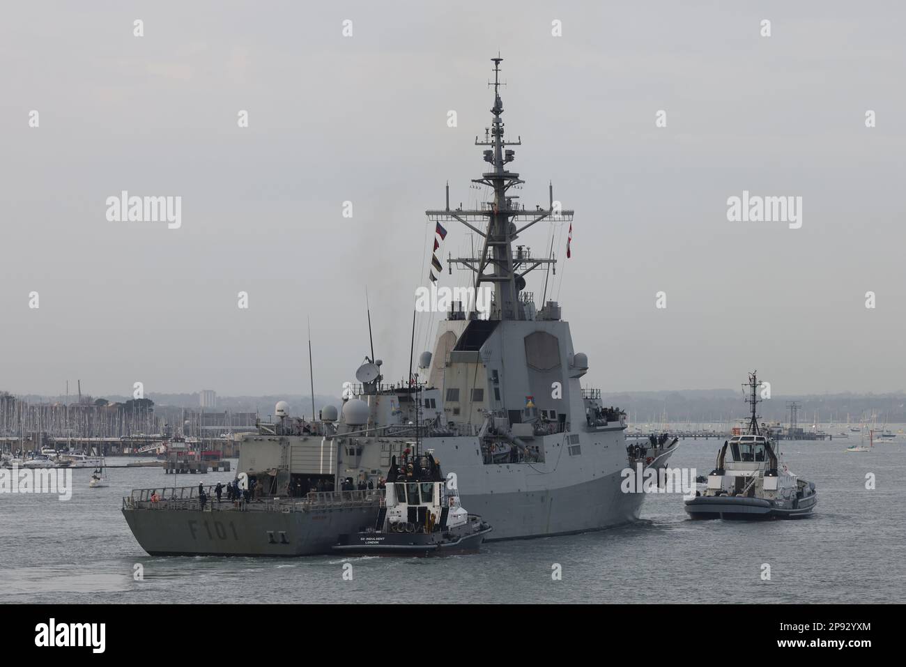 Tugs guide the Spanish navy guided missile frigate ALVARO DE BAZAN towards a berth in the Naval Base Stock Photo