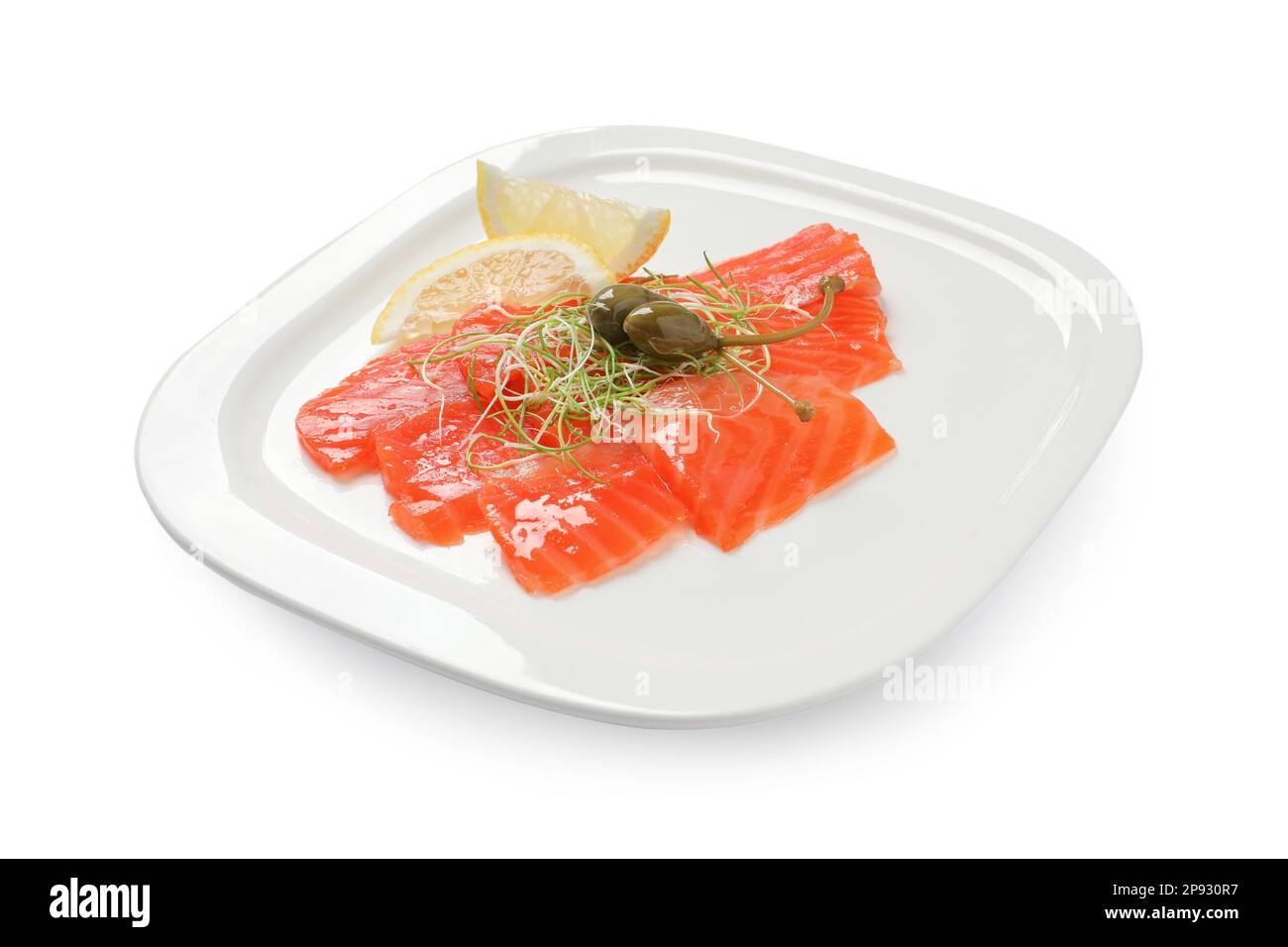 Salmon carpaccio with capers, microgreens and lemon isolated on white