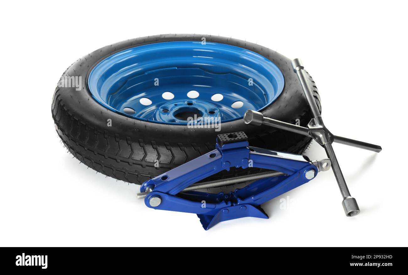 Car wheel, scissor jack and cross torque wrench on white background