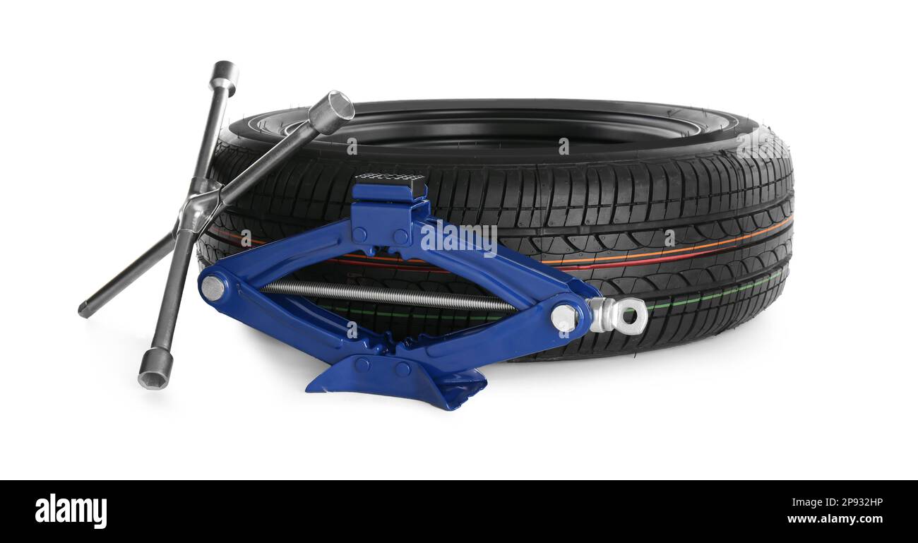 Car wheel, scissor jack and cross torque wrench on white background
