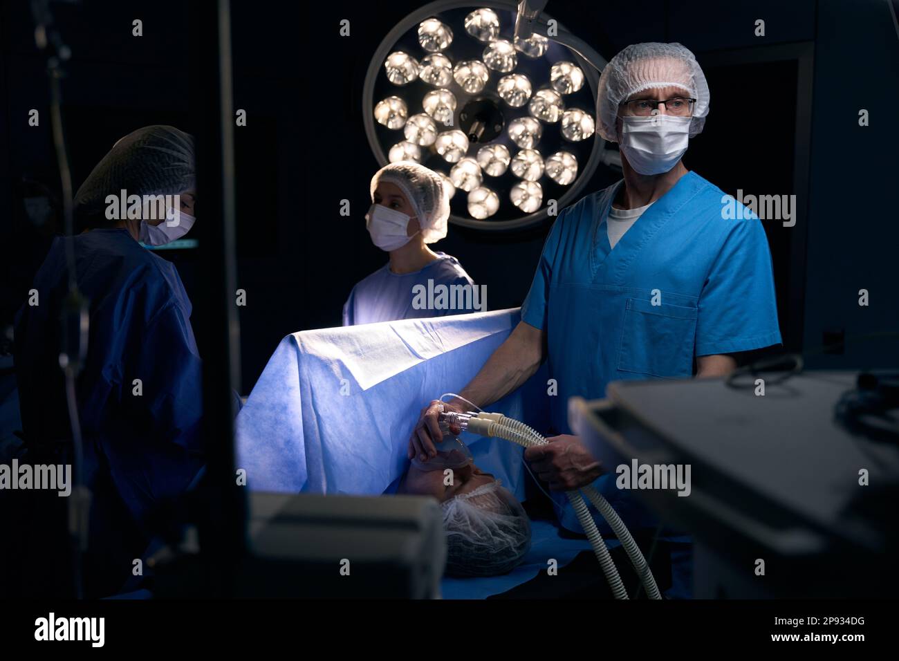 Anesthesiologist doctor holds mask with anesthesia in front of patient ...