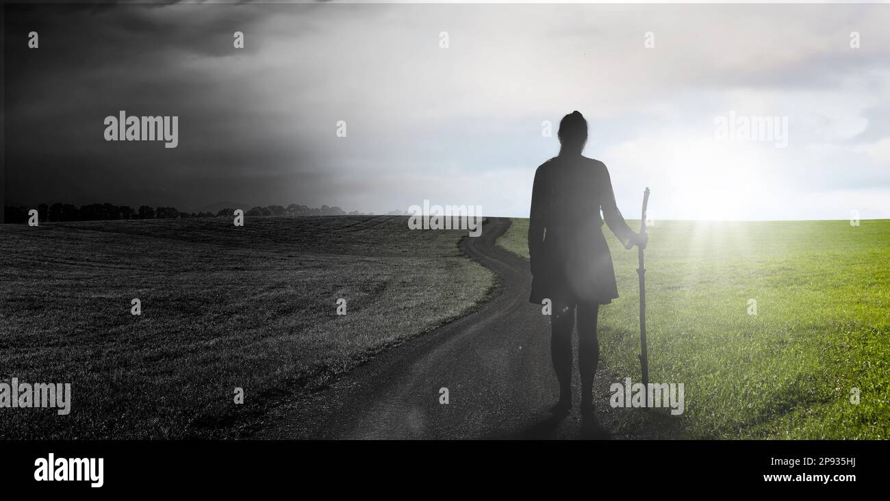 Silhouette of a pilgrim in a landscape with climate change Stock Photo