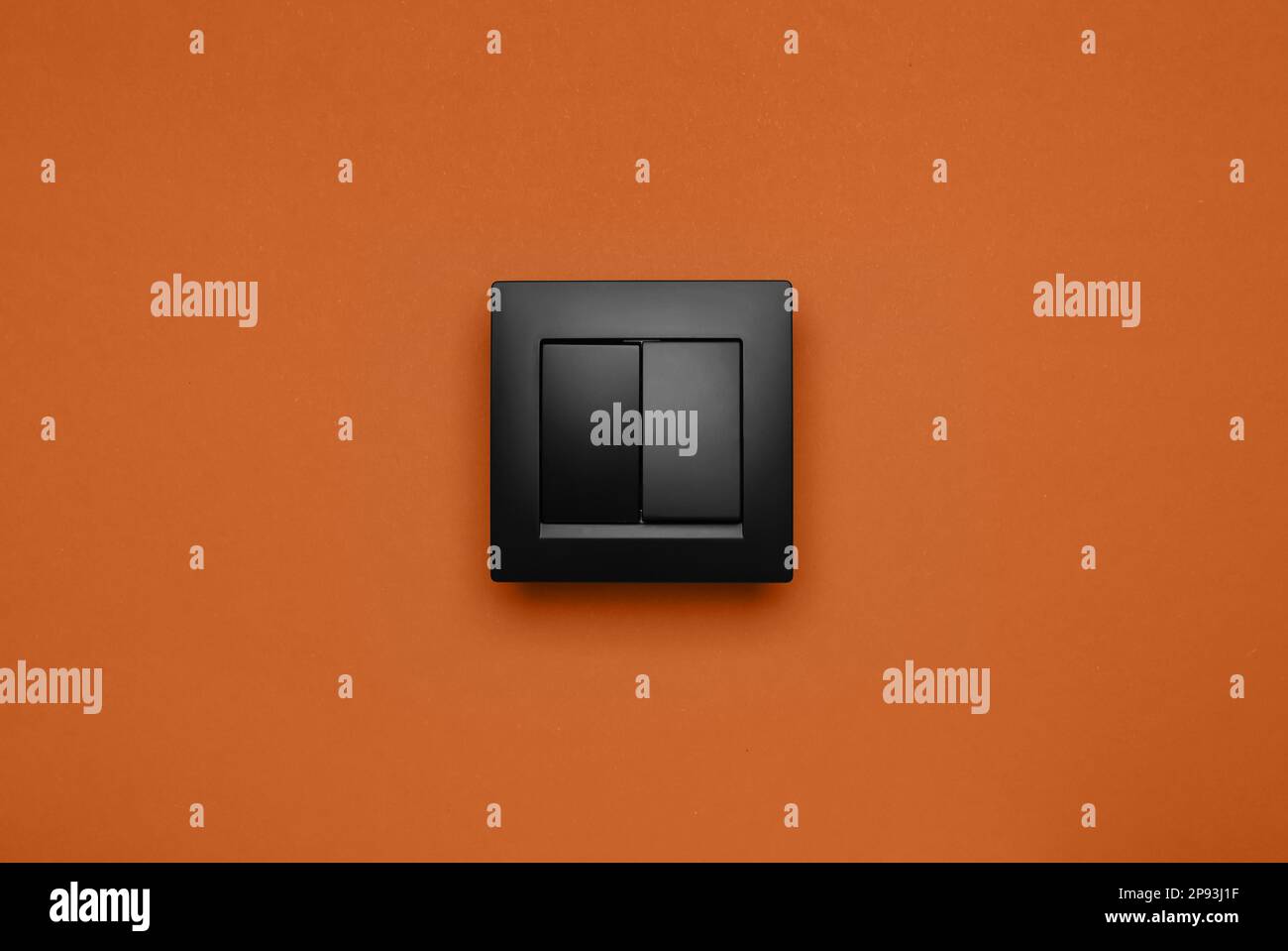 Black plastic light switch on orange background Stock Photo Alamy