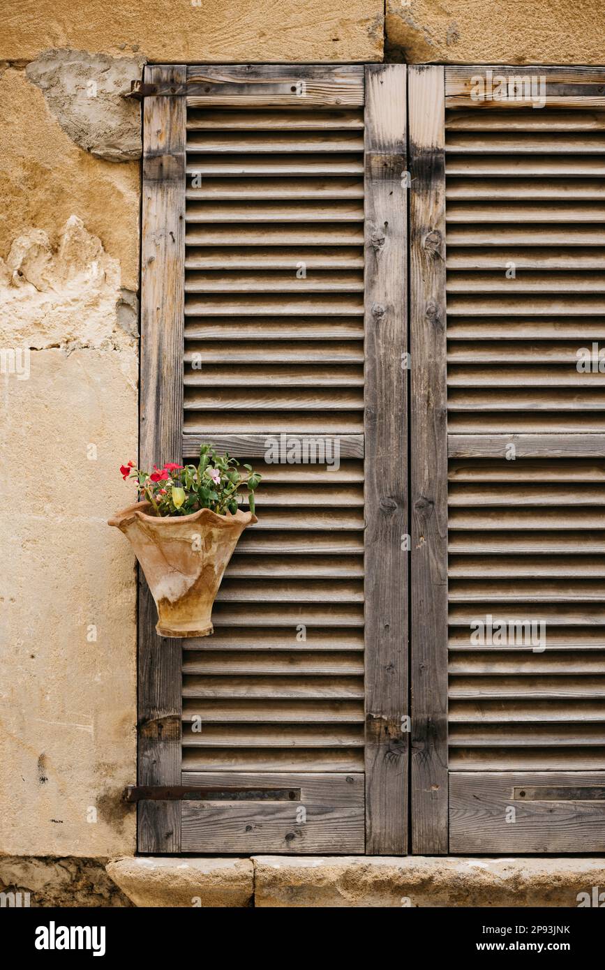 Shuttered wooden window store in the old town of Pollença in Mallorca ...