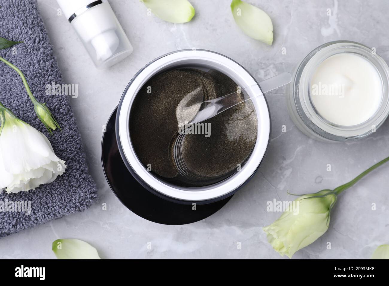 Flat lay composition with under eye patches on light grey marble table ...