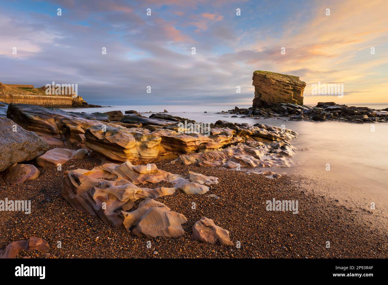 England, Northumberland, Seaton Sluice. Sunrise at Charlies Garden, a rock formation located in Collywell Bay, Seaton Sluice. Stock Photo