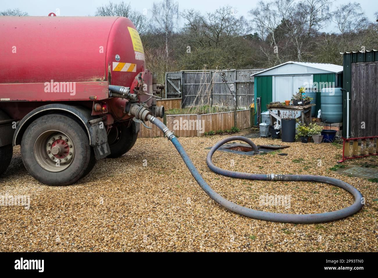 Emptying the septic tank at a house in the country that is not connected to mains sewerage. Stock Photo