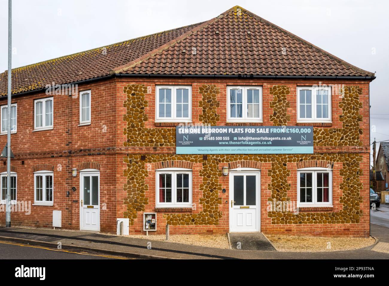 Ten One Bedroom Flats For Sale sign on building in Norfolk village. Stock Photo