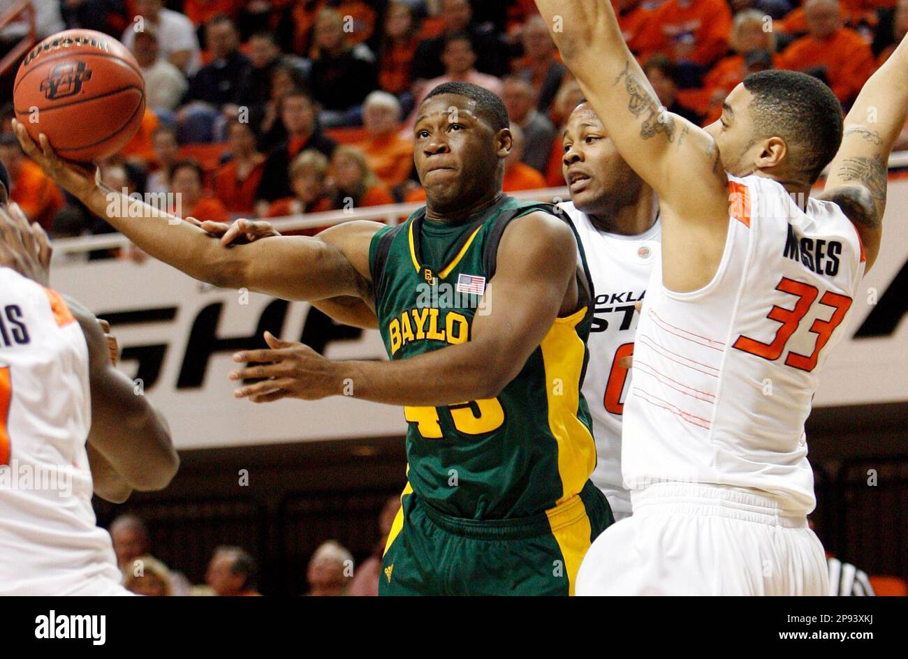 Baylor's Tweety Carter (45) shoots as Oklahoma State's Marshall Moses (33),  right, and Byron Eaton (00) defend in the first half of the NCAA college  basketball game at Gallagher-Iba Arena in Stillwater,