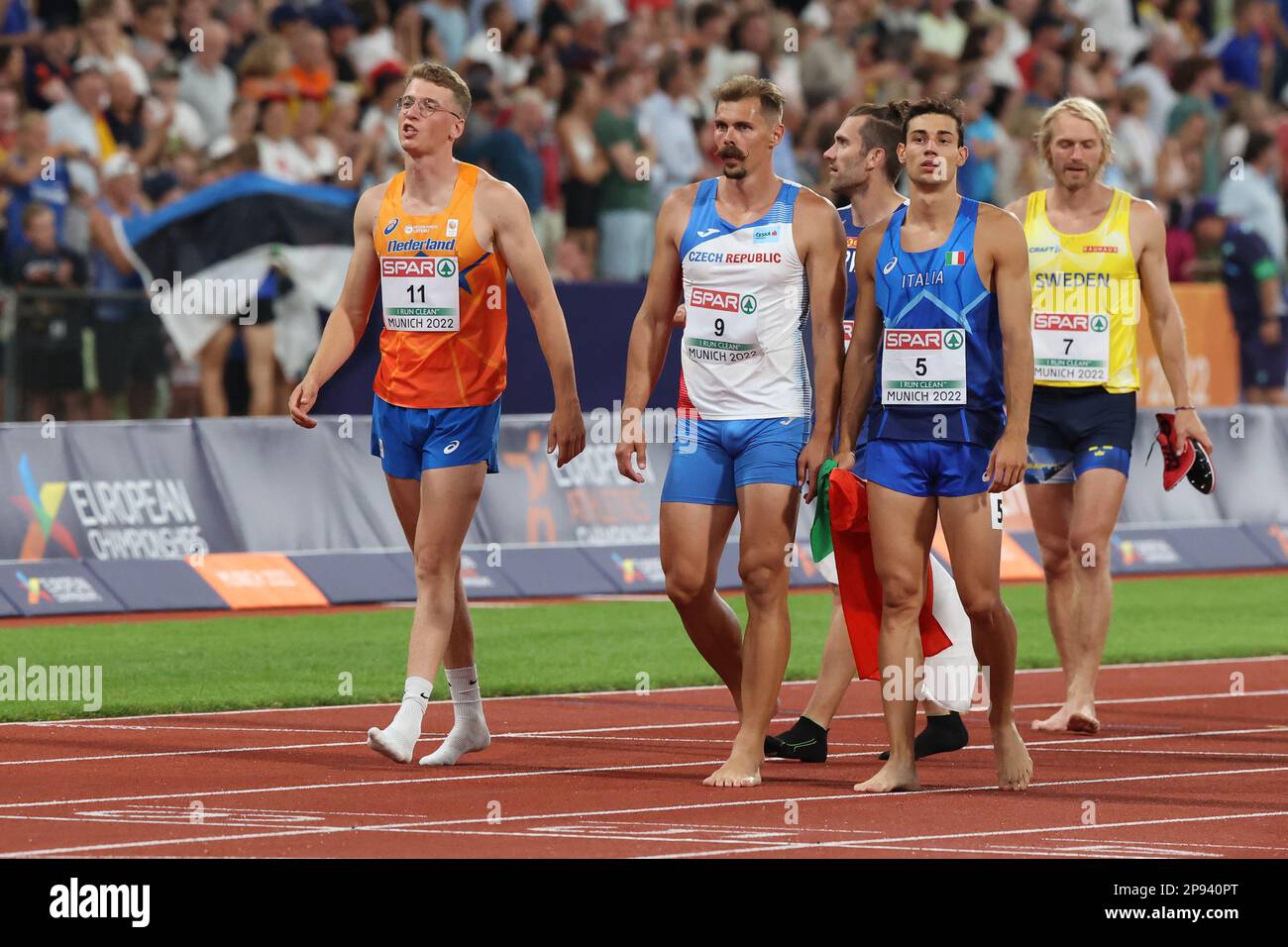 Decathletes walking across the track at the end of the decathlon at the European Athletics Championship 2022 Stock Photo