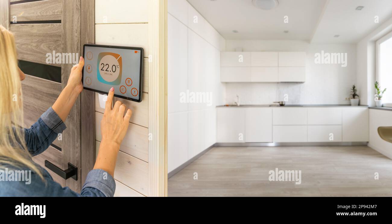 Woman using smart wall home control system Stock Photo