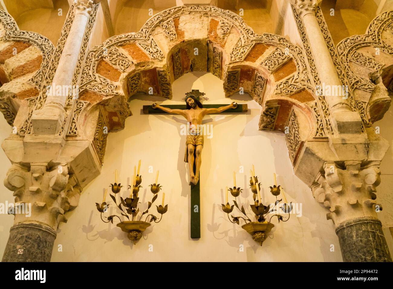 Christian crucifixion motive below Moorish architectural elements. Interior of the Great Mosque of Cordoba or La Mezquita, Cordoba, Cordoba Province, Stock Photo