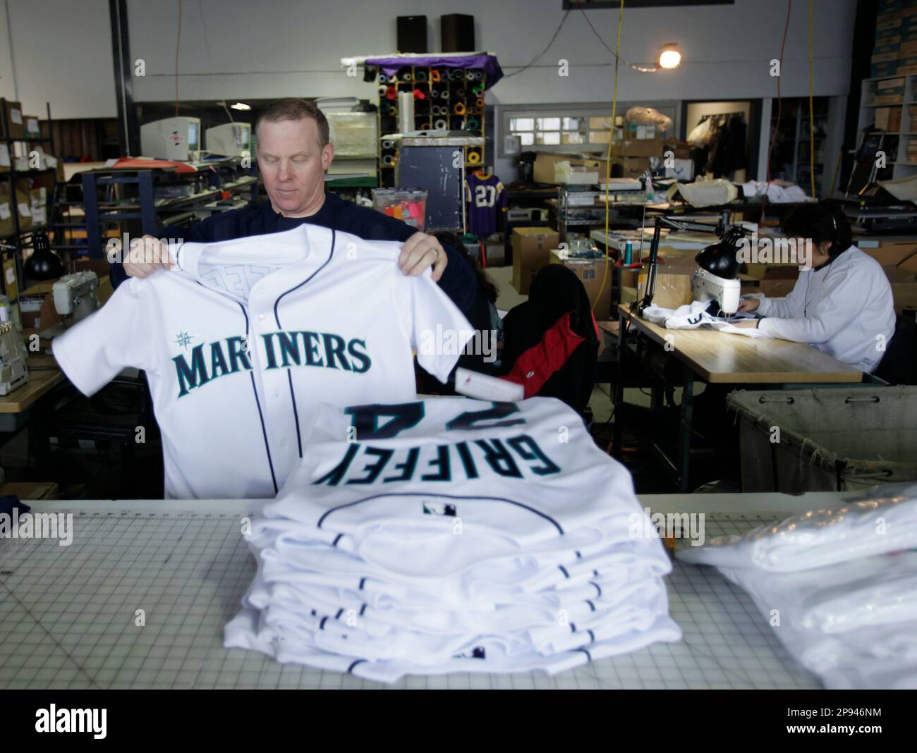 Jerry Thornton, owner of STT Sports Lettering Co., folds official Ken  Griffey Jr. MLB baseball jerseys sewn in the Seattle shop Thursday, Feb.  19, 2009. The Mariners announced late Wednesday that Griffey