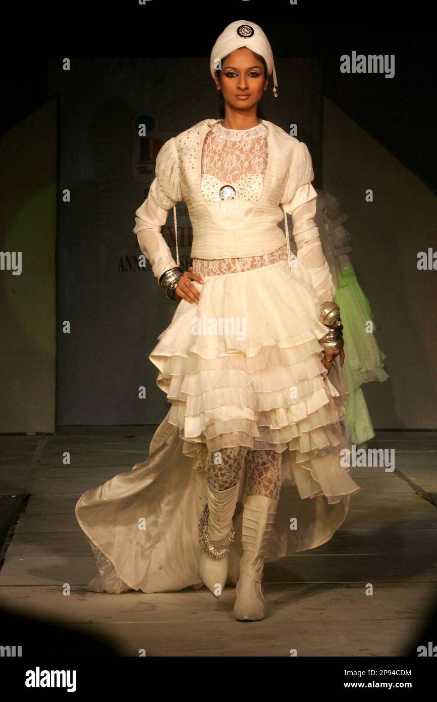 A model displays an outfit designed by graduating students of the Inter ...