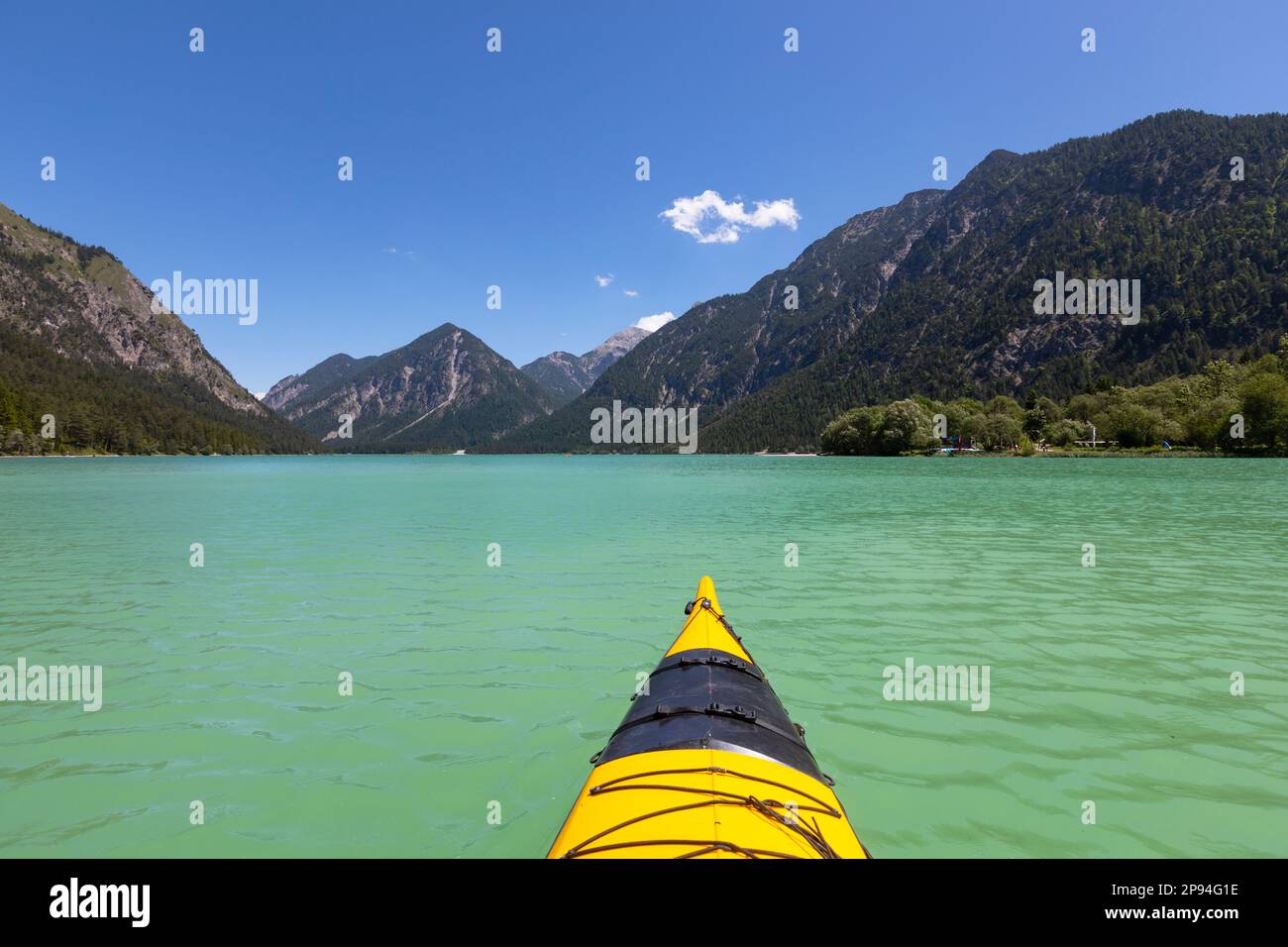 Bow tip of a yellow sea kayak on Lake Heiterwang. Stock Photo