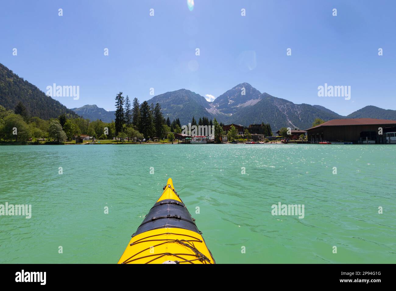 Bow tip of a yellow sea kayak on Lake Heiterwang. Stock Photo