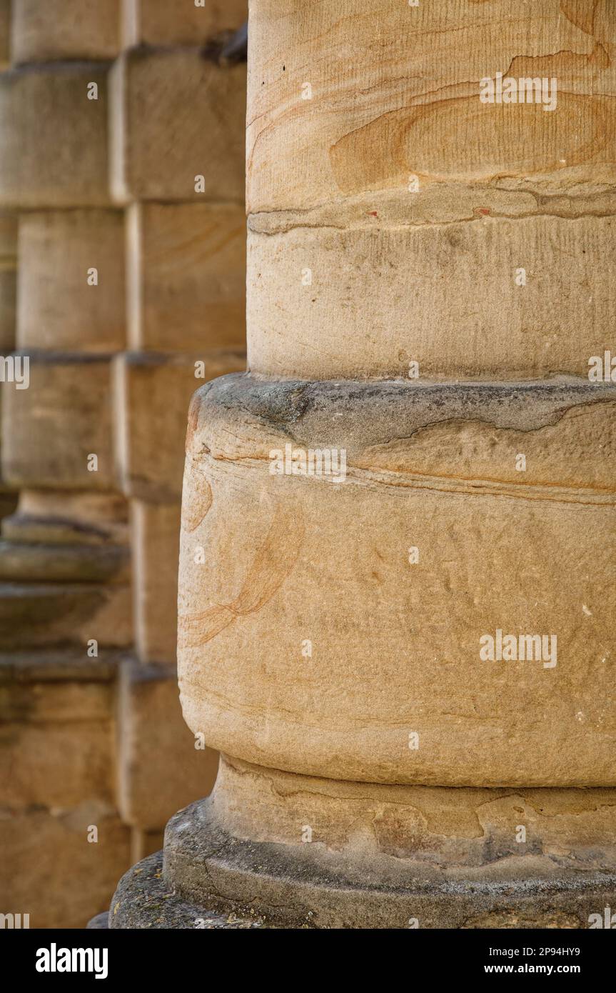 A vertical shot of aged columns built into the stone wall Stock Photo ...