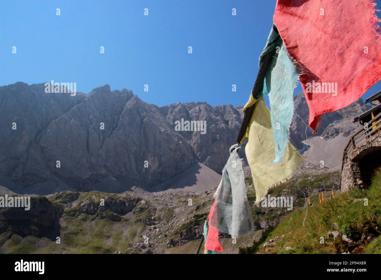 Prayer flags at Coburger Hütte, DAV hut, above Seebensee, Mieminger mountain range. Ehrwald, Tyrol, Austria Stock Photo