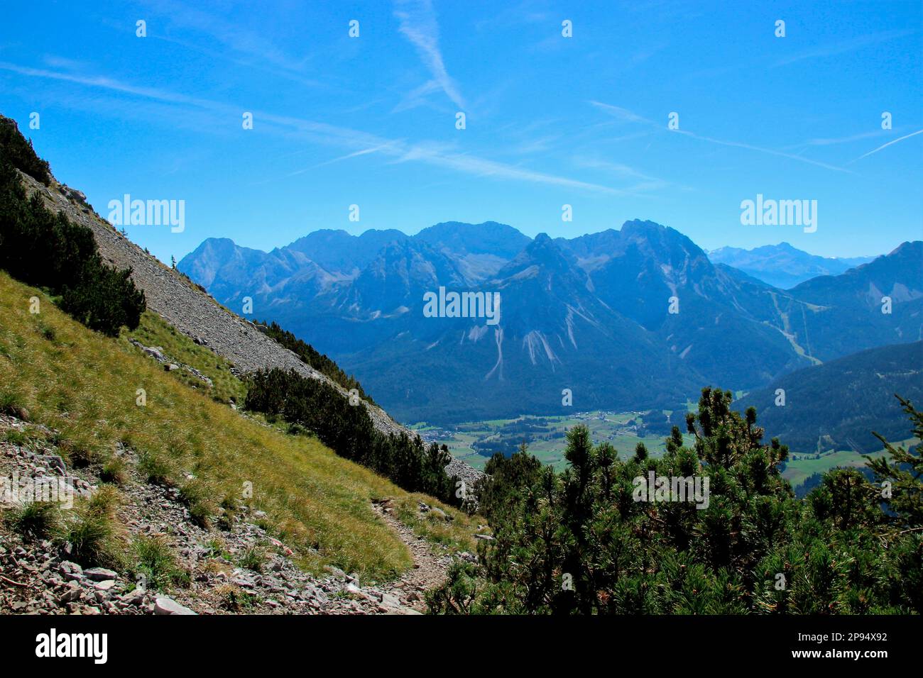 View during the descent from the summit of Daniel (2340m), highest peak of the Ammergau Alps, to the Mieminger mountain range with the prominent peak of Sonnenspitze (2417m), Lermoos, Zugspitzarena, Tyrol, Austria Stock Photo